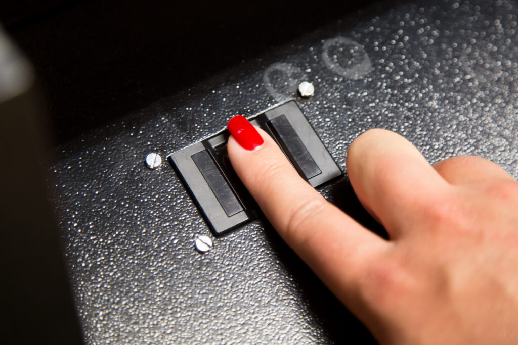 Woman's finger on fingerprint scanner